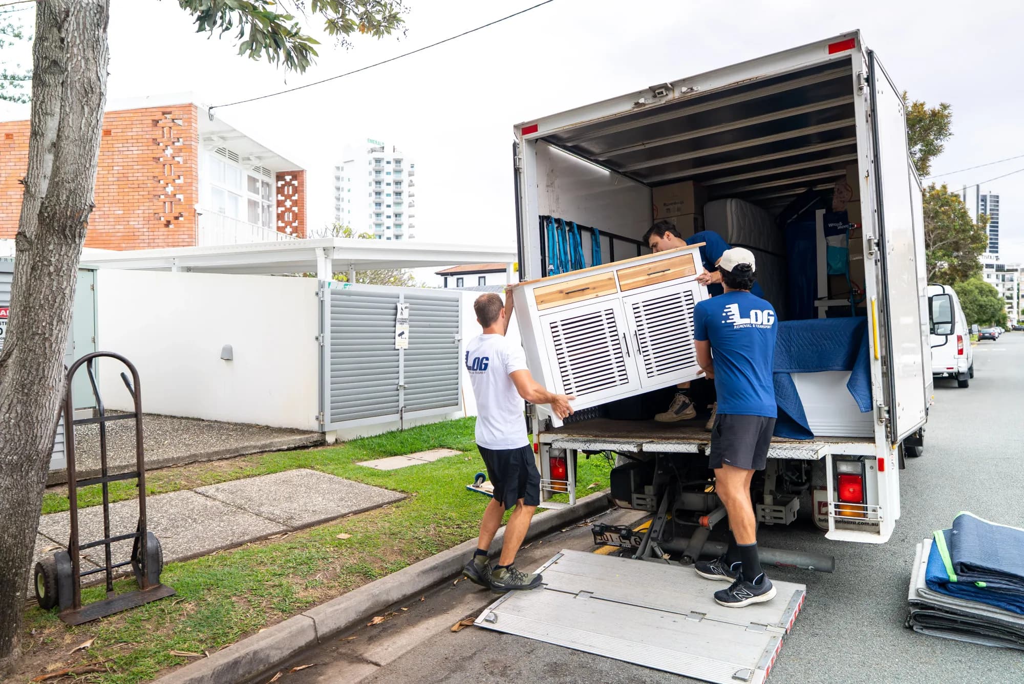 LOG movers loading household furniture into the removal truck