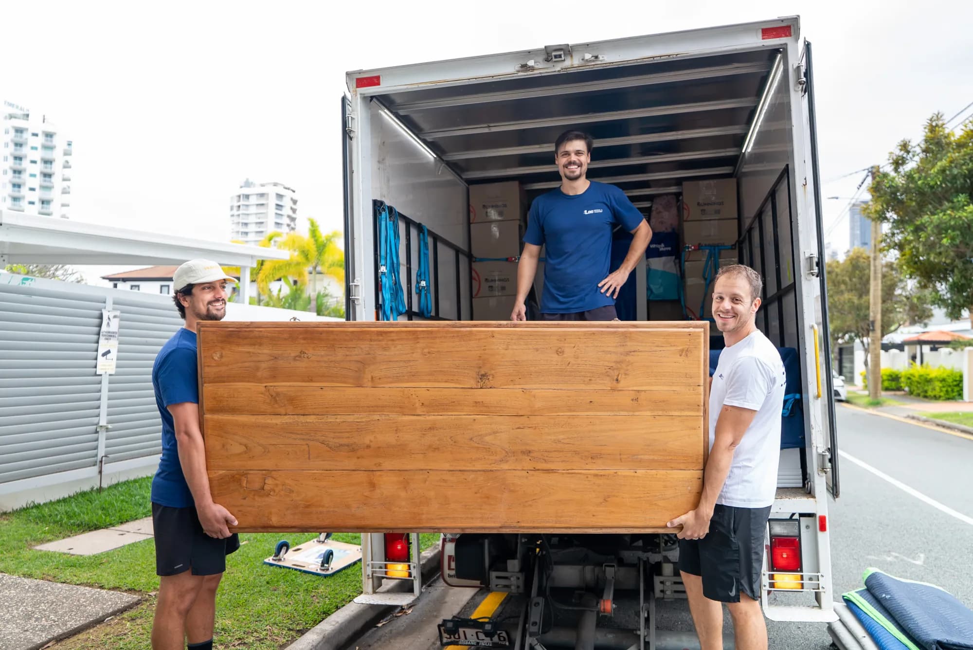 LOG Removal & Transport team carrying a large table