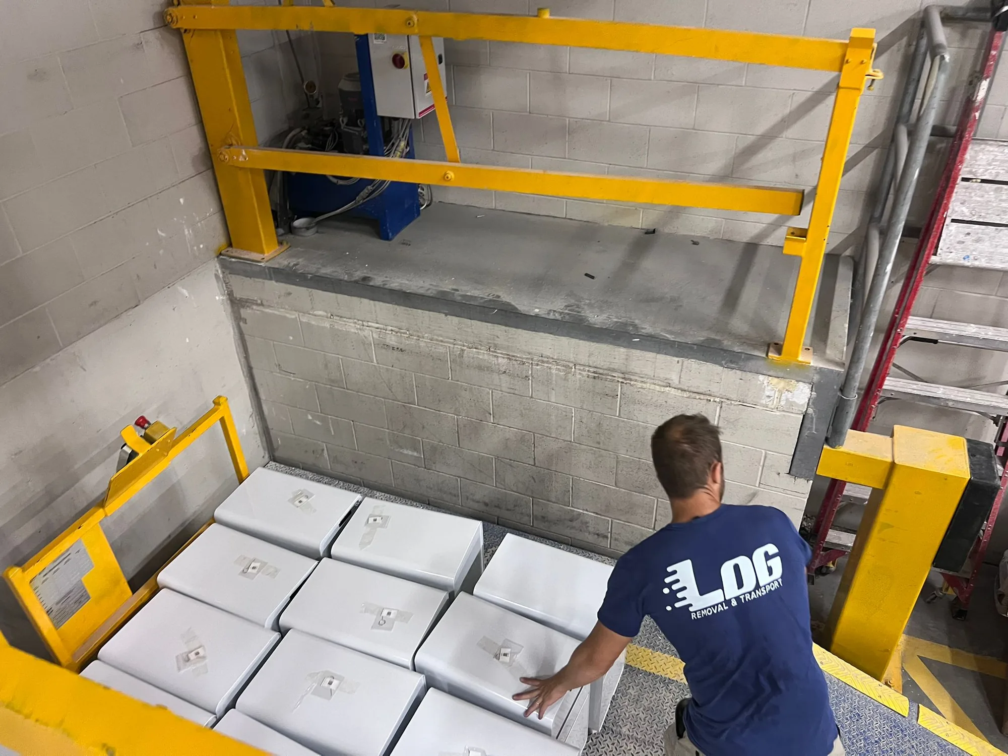 LOG Transport mover moving wrapped office items into a commercial goods lift