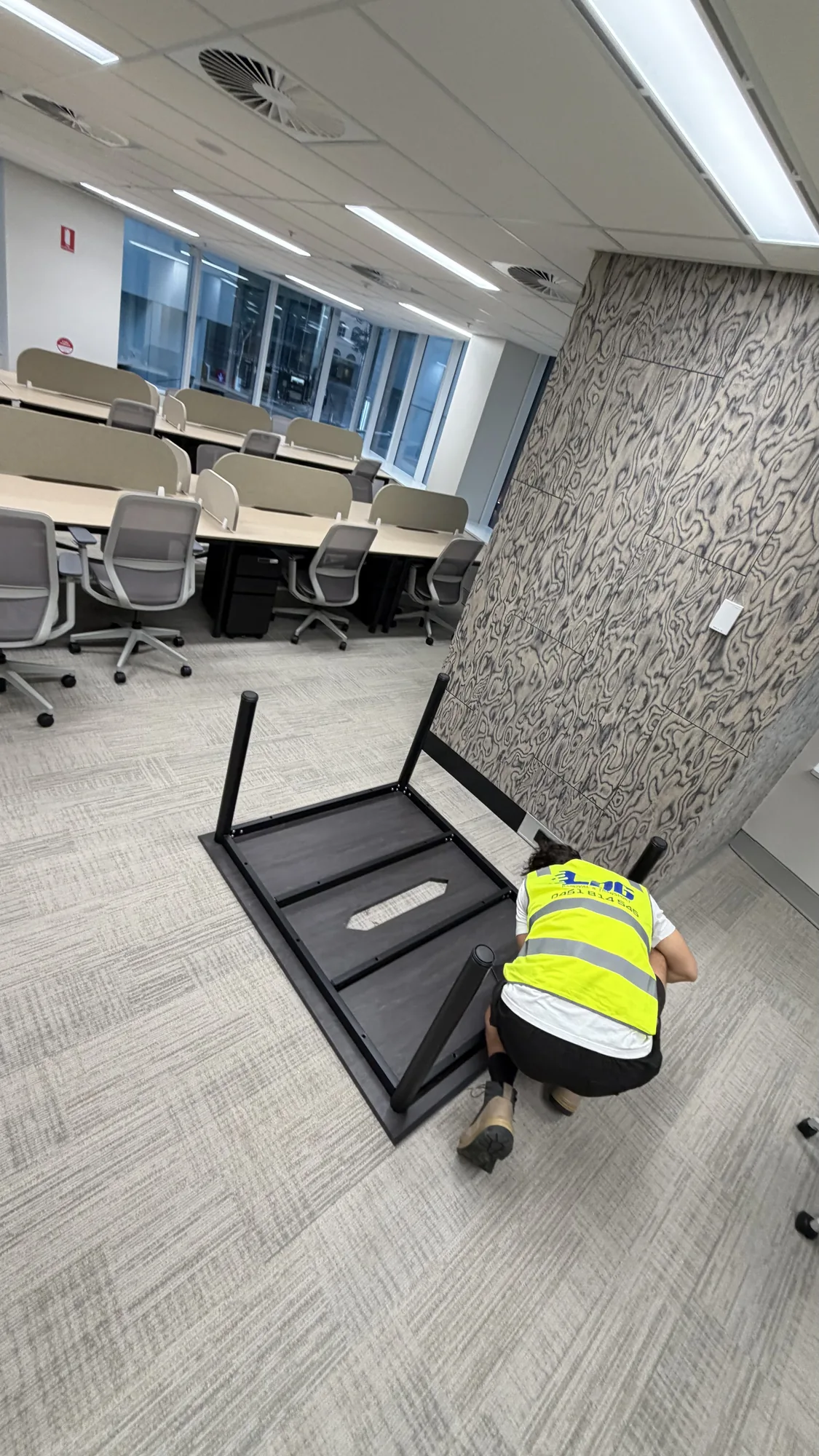 LOG Transport mover dismantling an office desk for reassembly during a commercial relocation
