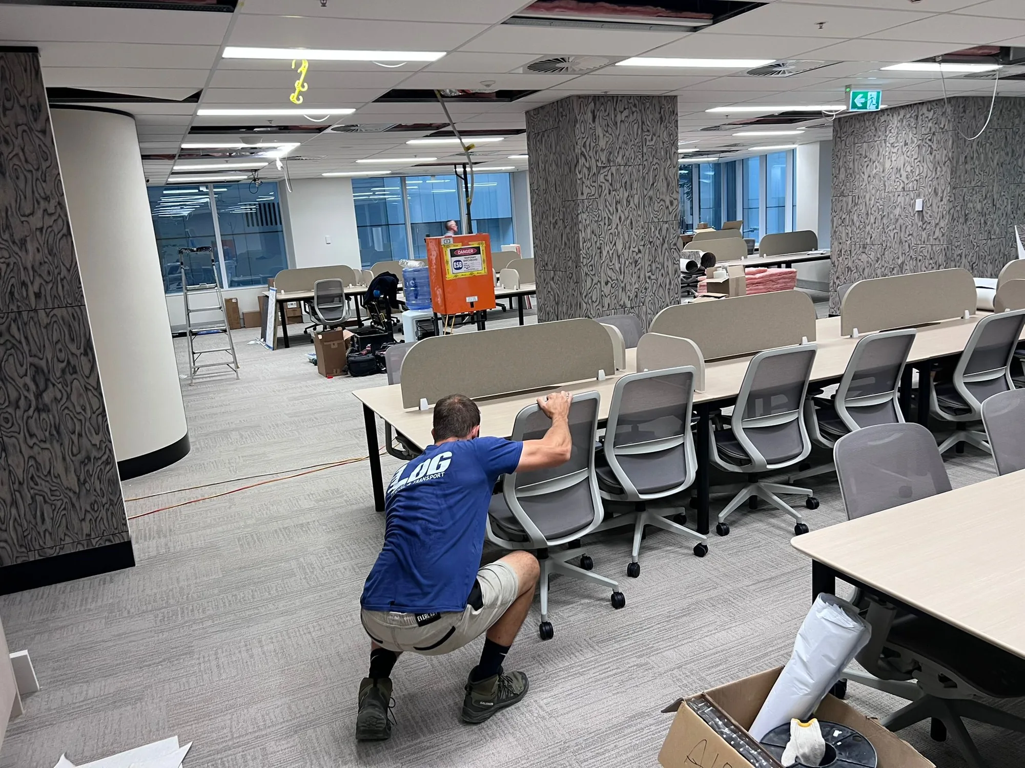LOG Transport mover setting up office workstations and chairs after a relocation