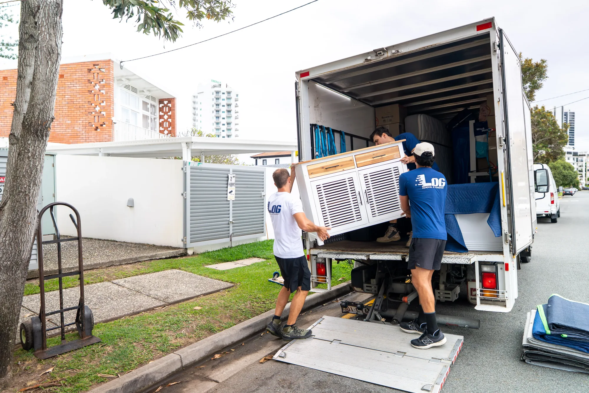 LOG Transport team loading furniture in front of a Surfers Paradise apartment building