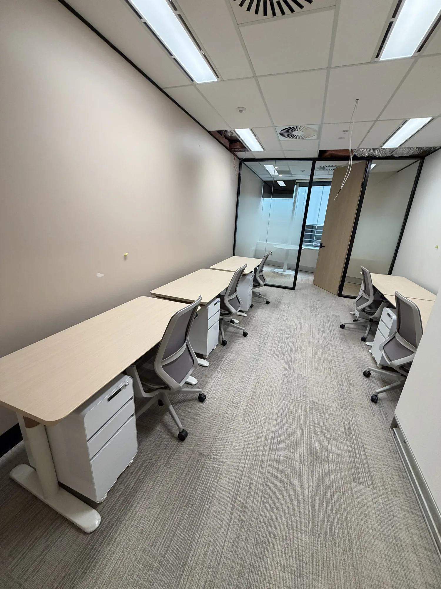 Office workstations set up by LOG Transport after a commercial relocation, with city views